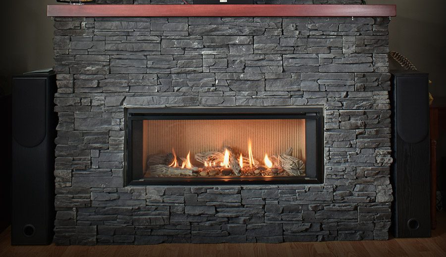 Stone gas fireplace installation by Schneiss Heating & Air Conditioning in West Bend WI