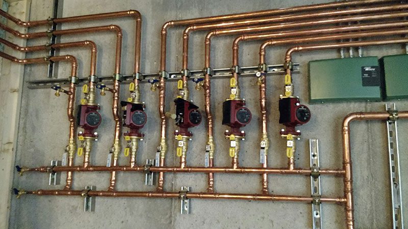 Heating pipes and meters in a commercial building in West Bend, WI